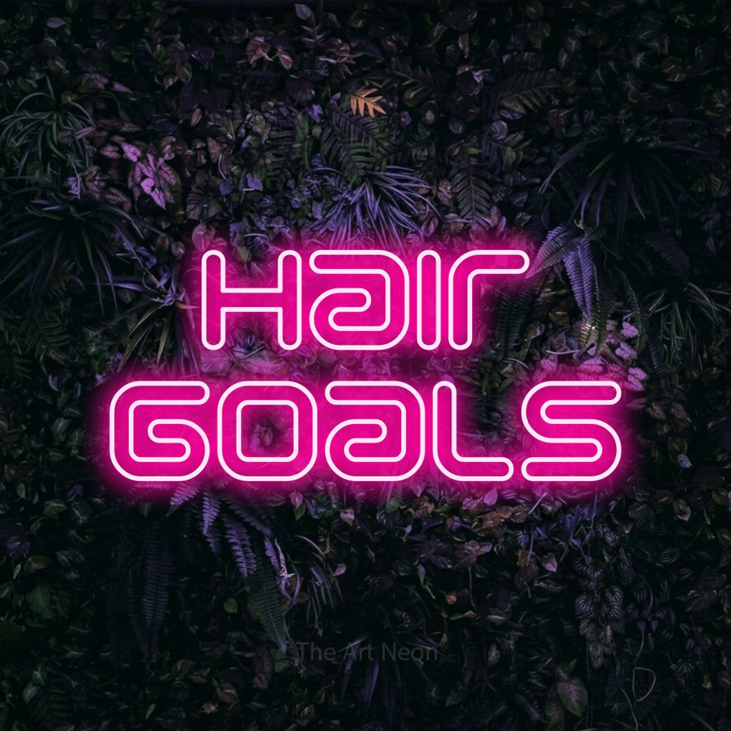LED neon sign reading “Hair Goals”, arranged in 2 lines.