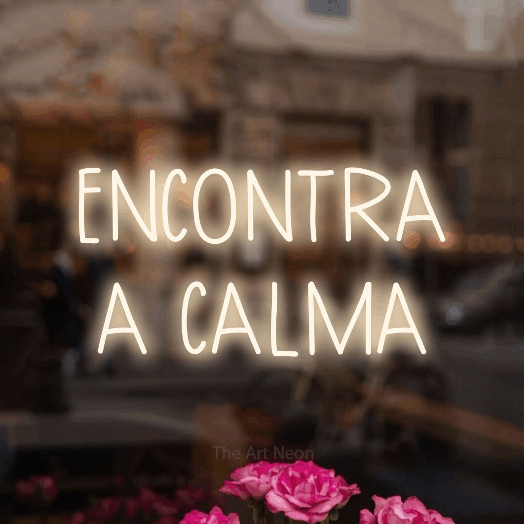 LED neon sign reading “ENCONTRA A CALMA”, arranged in 2 lines.