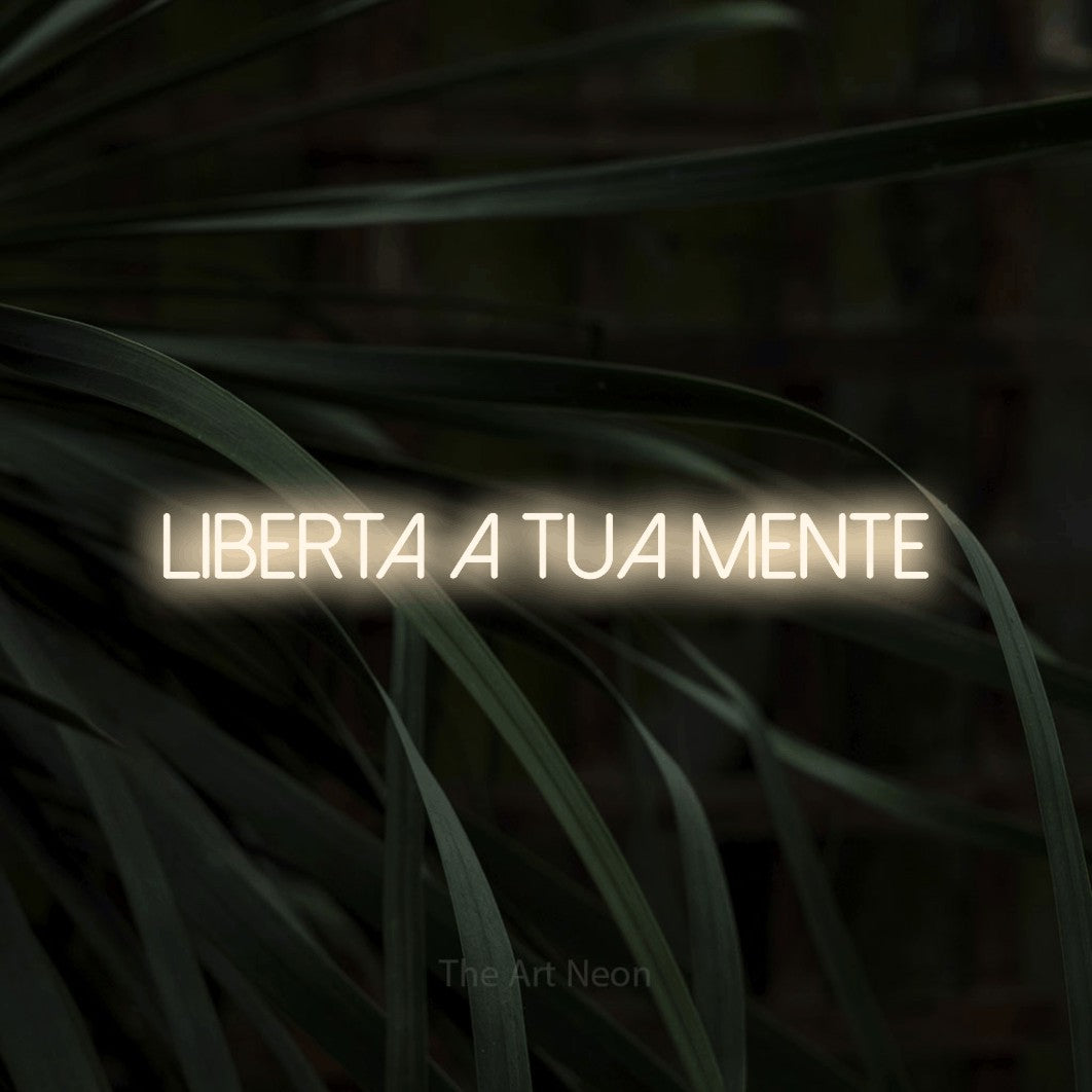 LED neon sign reading “Liberta a Tua Mente”, arranged in a single line.
