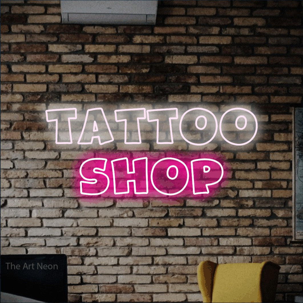 LED neon sign reading “tattoo shop”, arranged in 2 lines.