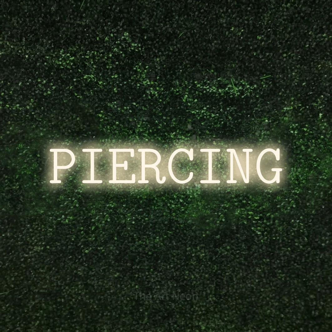LED neon sign reading “PIERCING”, arranged in a single line.