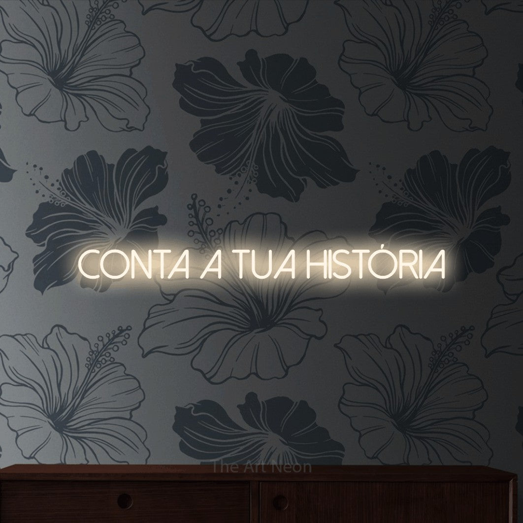 LED neon sign reading “conta a tua história”, arranged in a single line.