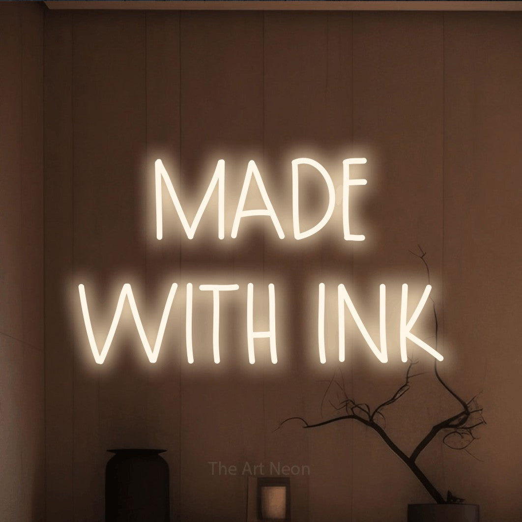 LED neon sign reading “MADE WITH INK”, arranged in 2 lines.