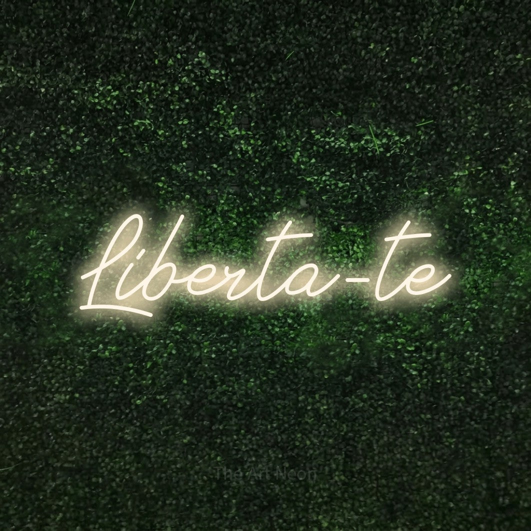 LED neon sign reading “Liberta-te”, arranged in a single line.