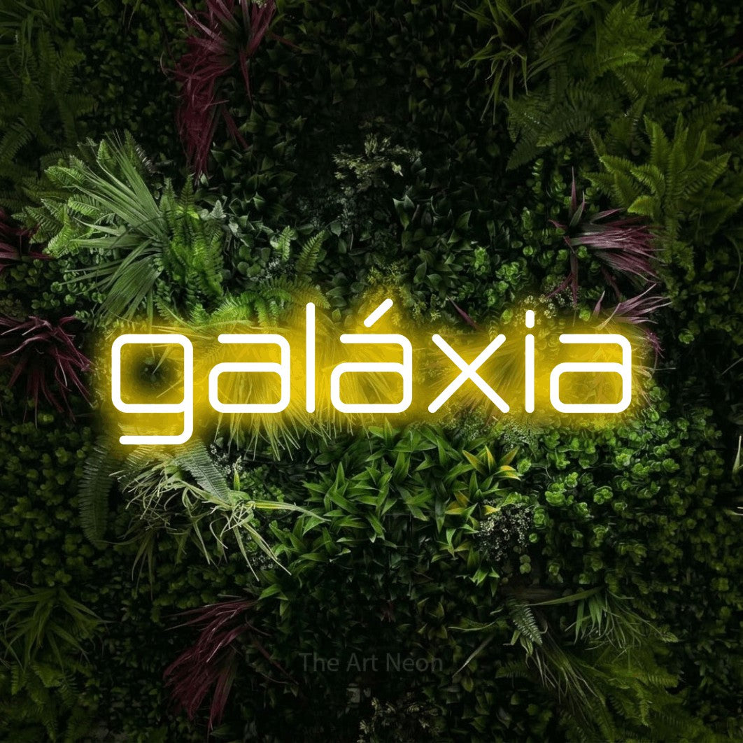 LED neon sign reading “galáxia”, arranged in a single line.