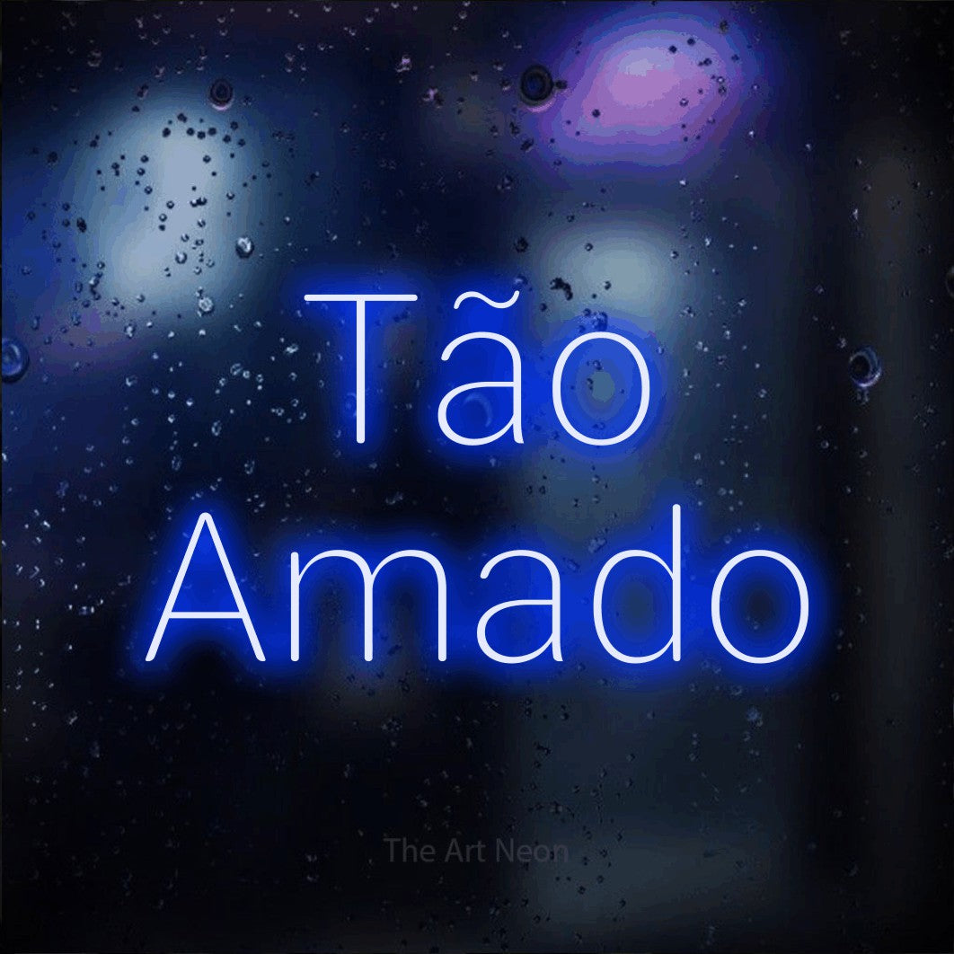 LED neon sign reading “Tão Amado”, arranged in 2 lines.