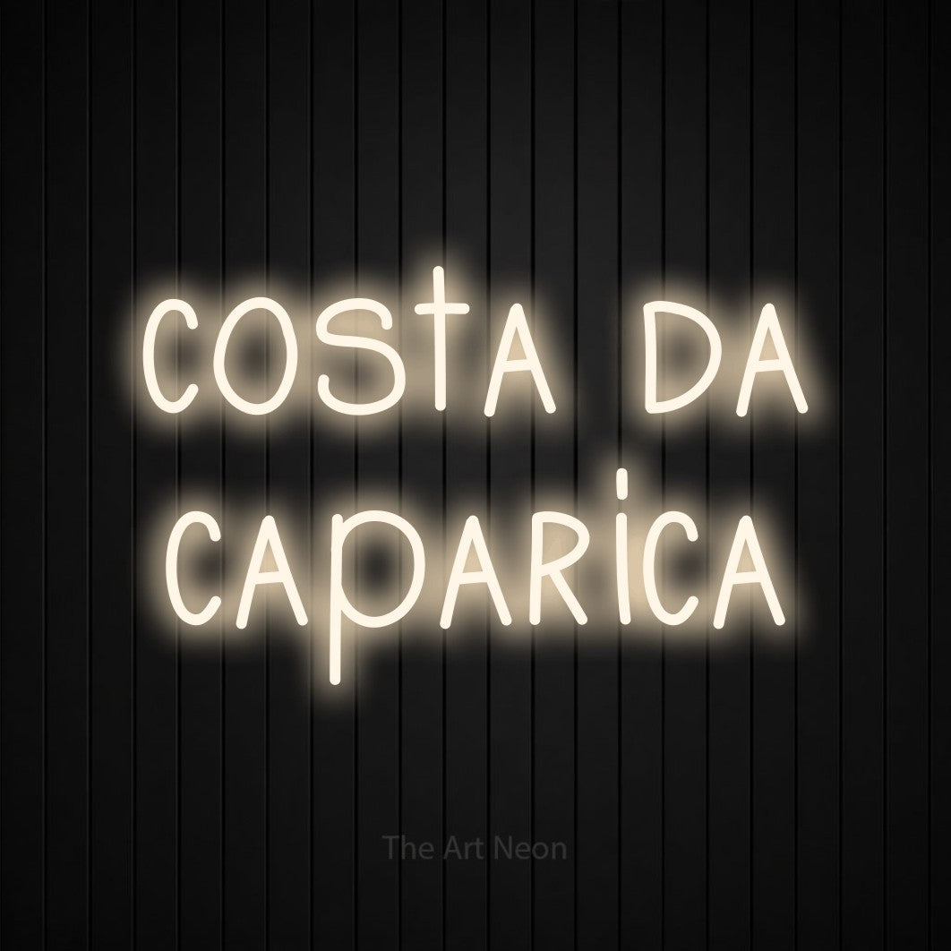 LED neon sign reading “costa da caparica”, arranged in 2 lines.