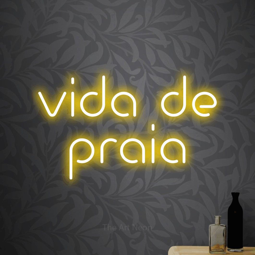 LED neon sign reading “vida de praia”, arranged in 2 lines.