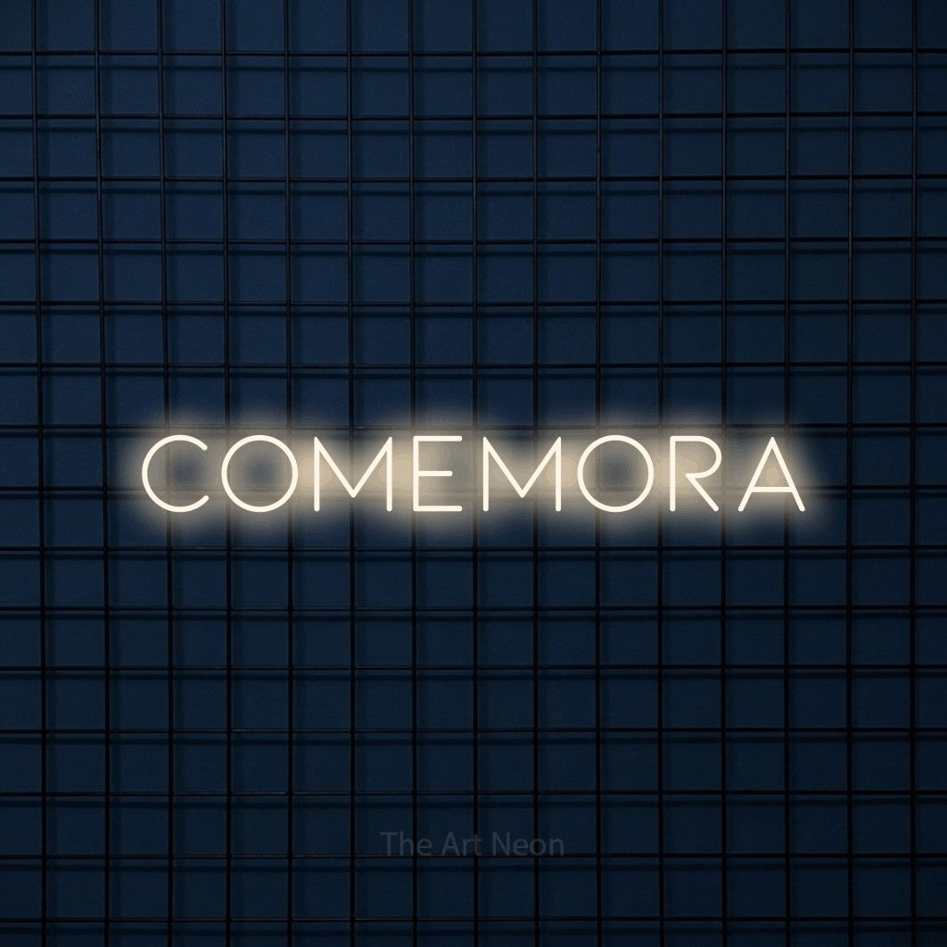 LED neon sign reading “Comemora”, arranged in a single line.