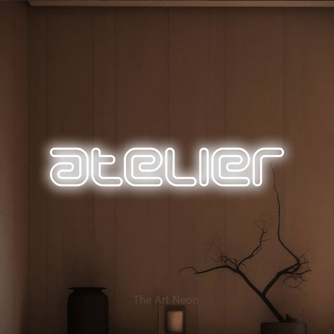 LED neon sign reading “atelier”, arranged in a single line.