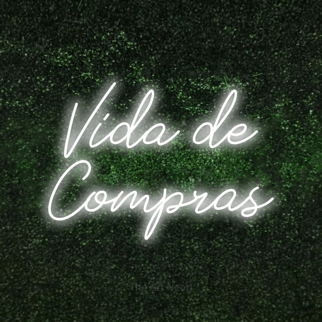LED neon sign reading “Vida de Compras”, arranged in 2 lines.