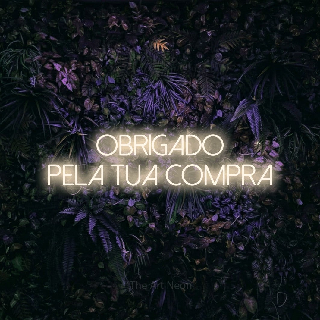 LED neon sign reading “obrigado pela tua compra”, arranged in 2 lines.