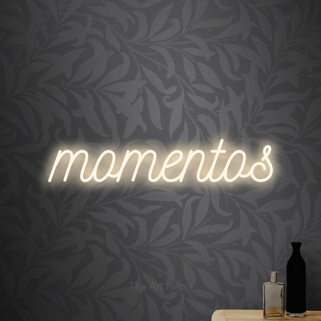 LED neon sign reading “momentos”, arranged in a single line.