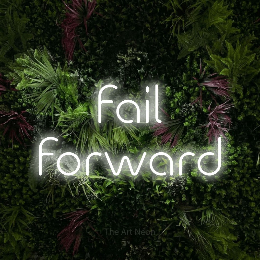 LED neon sign reading “fail forward”, arranged in 2 lines.