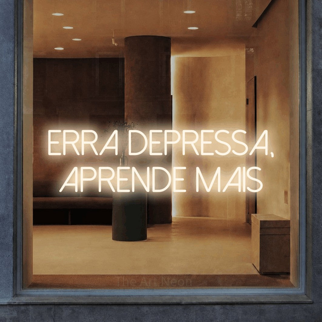 LED neon sign reading “erra depressa, aprende mais”, arranged in 2 lines.
