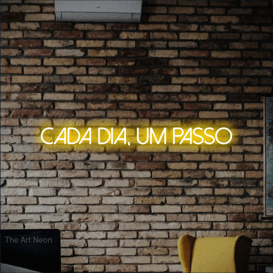 LED neon sign reading “cada dia, um passo”, arranged in a single line.