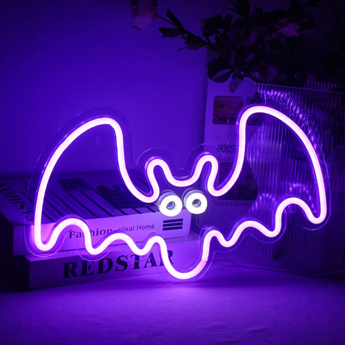 A imagem mostra uma vibrante placa de LED neon feita à mão em formato de morcego.