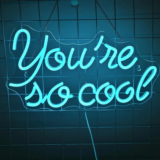 The image features a stylish, handmade LED neon sign displaying the phrase "You Are So Cool" in a vibrant ice blue color.