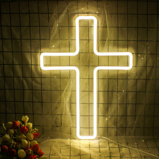 The image features a brightly illuminated LED neon sign in the shape of a cross.