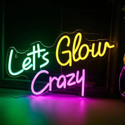 The image features a vibrant, handmade LED neon sign that reads "Let's Glow Crazy.