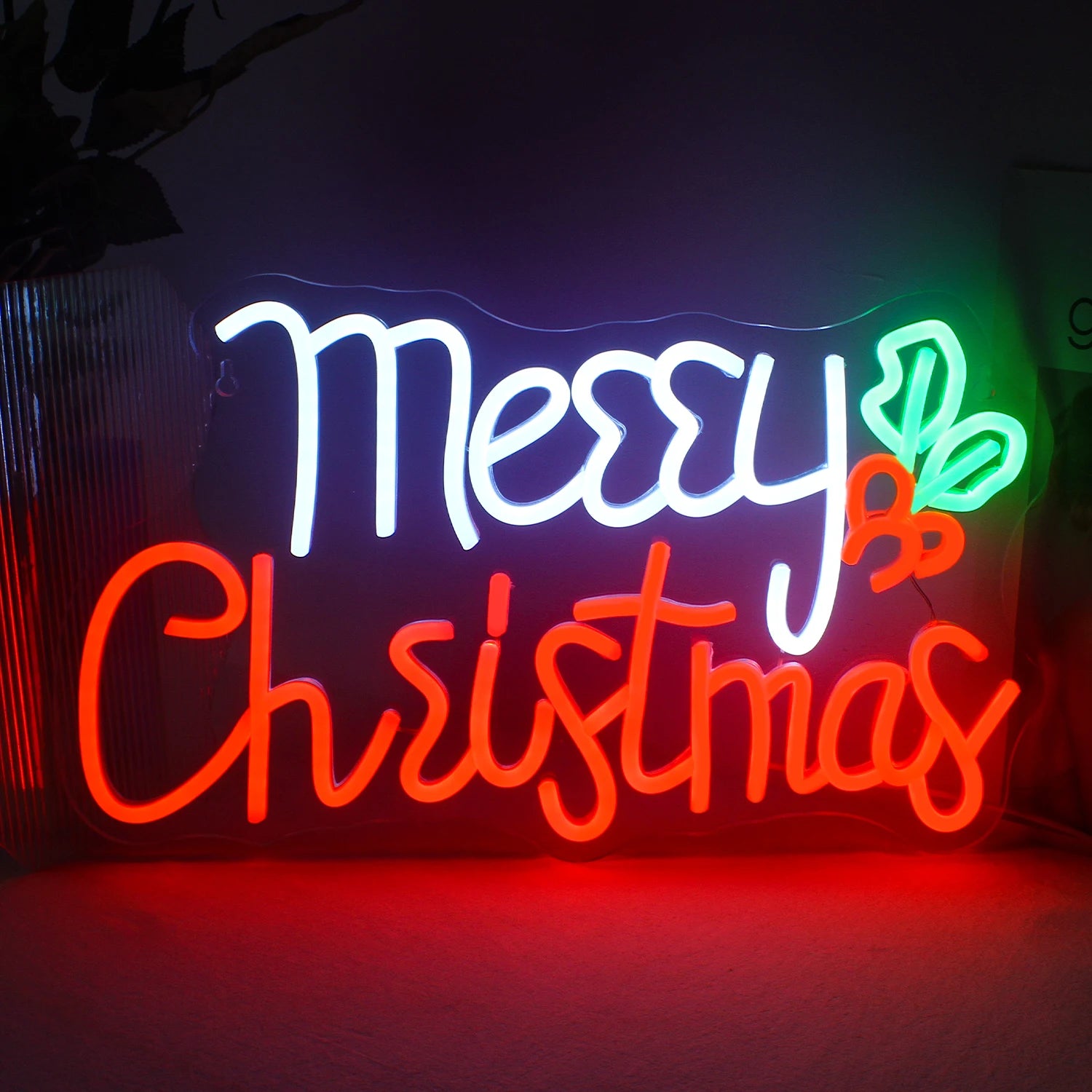 The image depicts a vibrant handmade LED neon sign displaying the words "Merry Christmas" in elegant, cursive lettering.