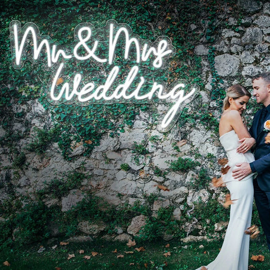 The image displays a stylish LED neon sign glowing with the words "Mr & Mrs" in an elegant cursive font.
