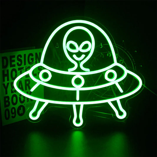 The image features a glowing LED neon sign in the shape of a friendly alien face.