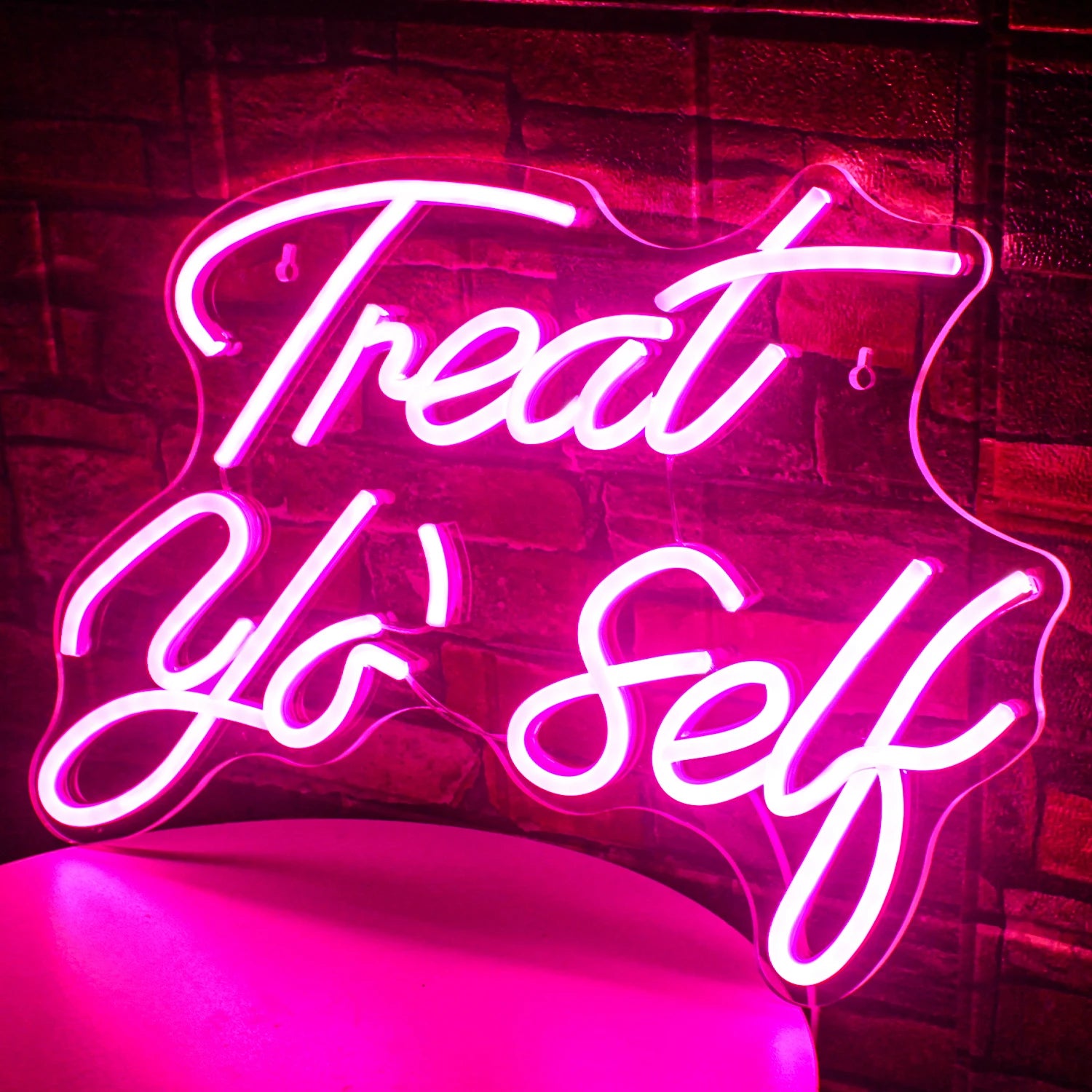The image features a vibrant LED neon sign displaying the words "Treat Yo' Self" in a stylish, cursive font.