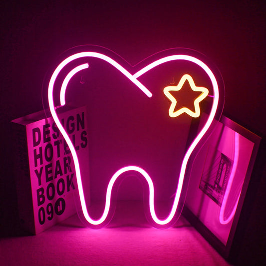 The image features a vibrant pink LED neon sign shaped like a stylized tooth.