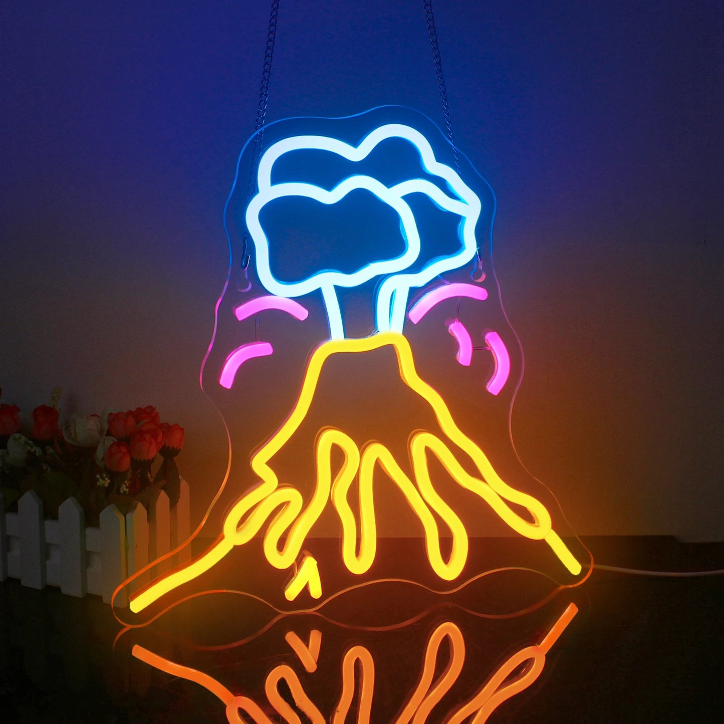 The image displays a vibrant LED neon sign in the shape of a volcano.