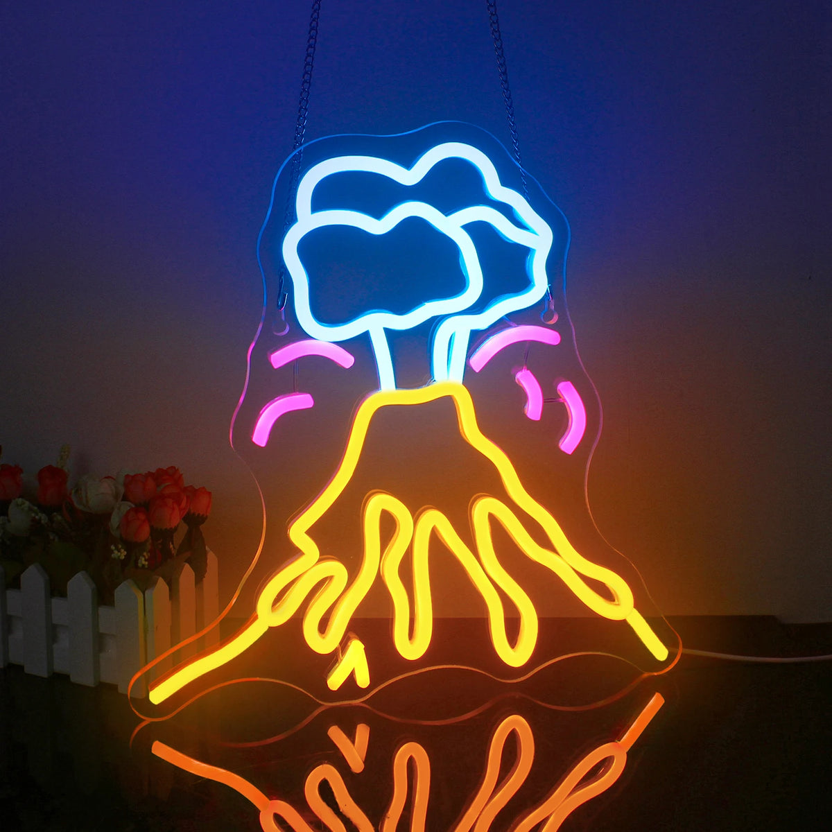 The image displays a vibrant LED neon sign in the shape of a volcano.