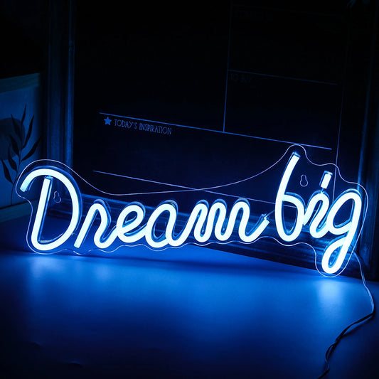 The image features a vibrant LED neon sign displaying the phrase "Dream Big.