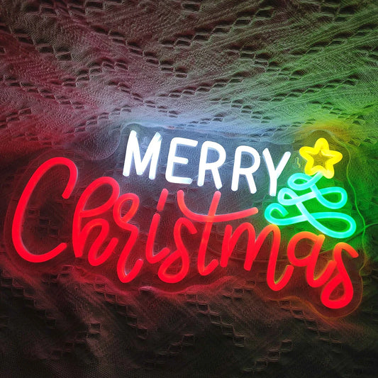 The image features a vibrant, handmade LED neon sign that spells out "Merry Christmas" in elegant, flowing script.