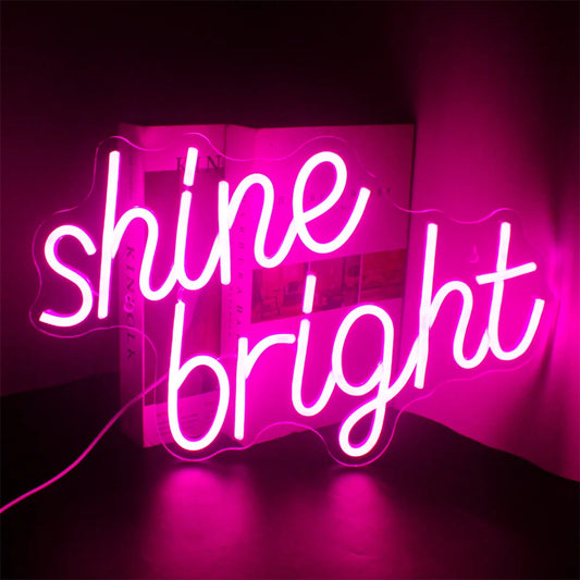 The image showcases a vibrant and stylish LED neon sign that reads "Shine Bright" in elegant, cursive handwriting.