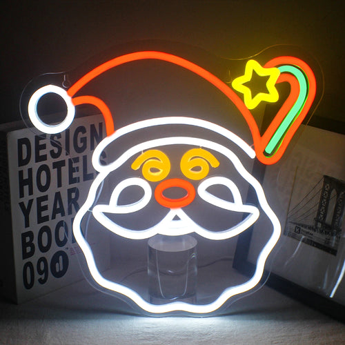 Uma vibrante placa de LED neon com tema natalino, apresentando uma variedade de símbolos festivos iluminados em cores brilhantes.