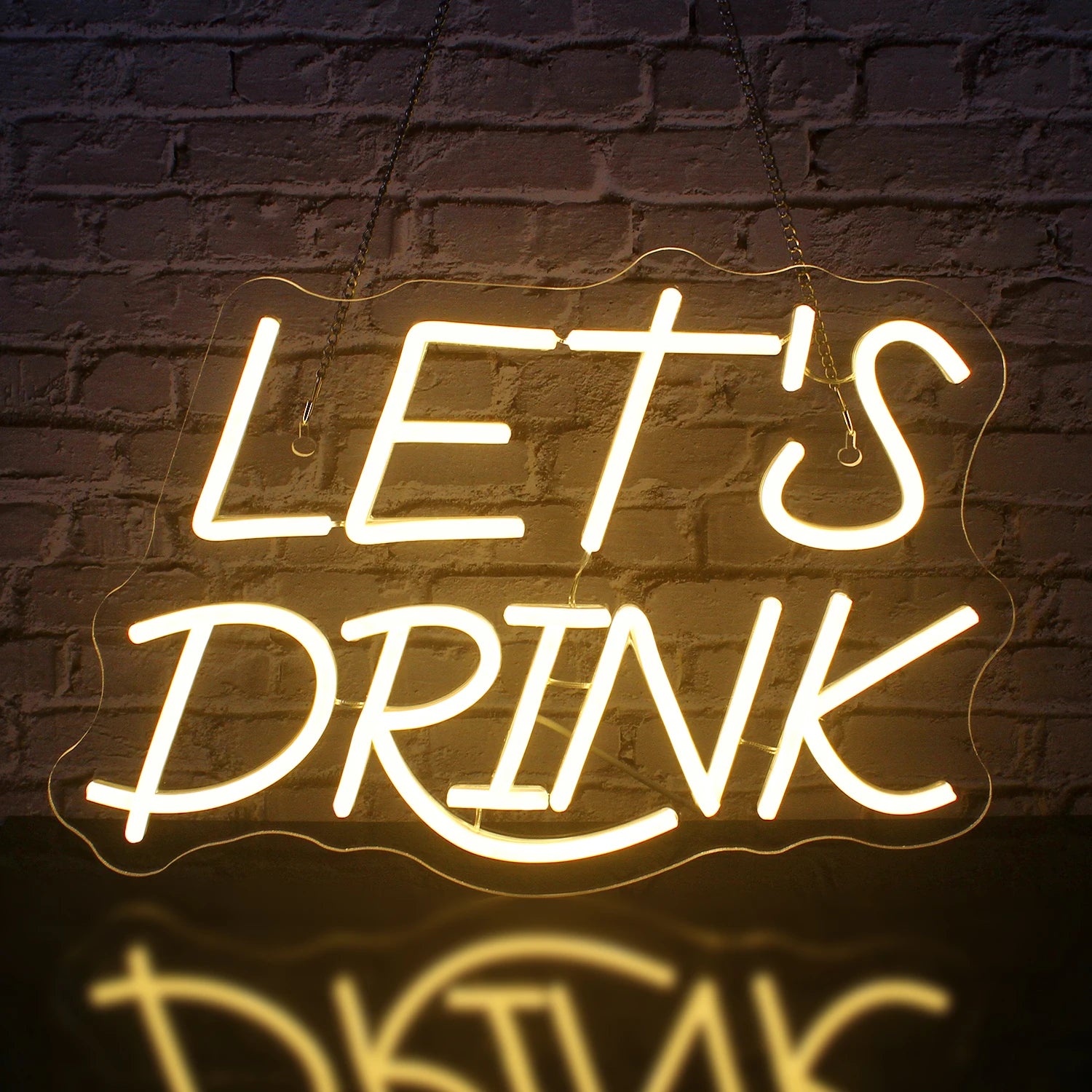 A vibrant LED neon sign with the words "Let's Drink" glowing in bright white.