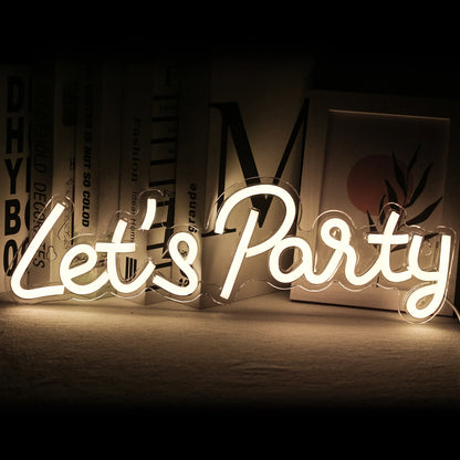 The image features a vibrant, handmade LED neon sign that reads "Let's Party" in playful, cursive script.