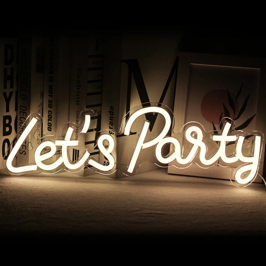 The image features a vibrant, handmade LED neon sign that reads "Let's Party" in playful, cursive script.