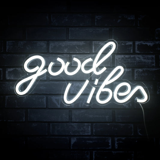The image features a handcrafted LED neon sign displaying the words "Good Vibes" in a stylish, cursive font.