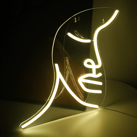 A vibrant handmade LED neon sign featuring a stylized illustration of a face.
