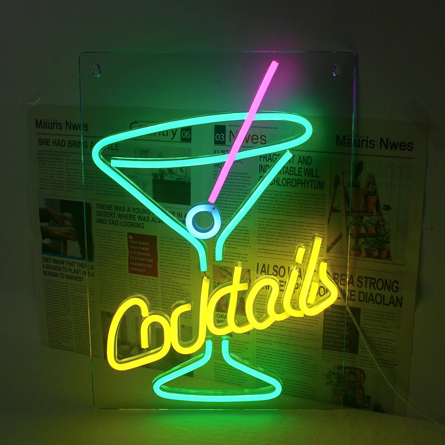 The image displays a vibrant green LED neon sign in the shape of a cocktail glass.