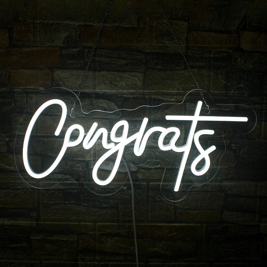 The image features a handmade LED neon sign displaying the word "Congrats" in a stylish, flowing script.