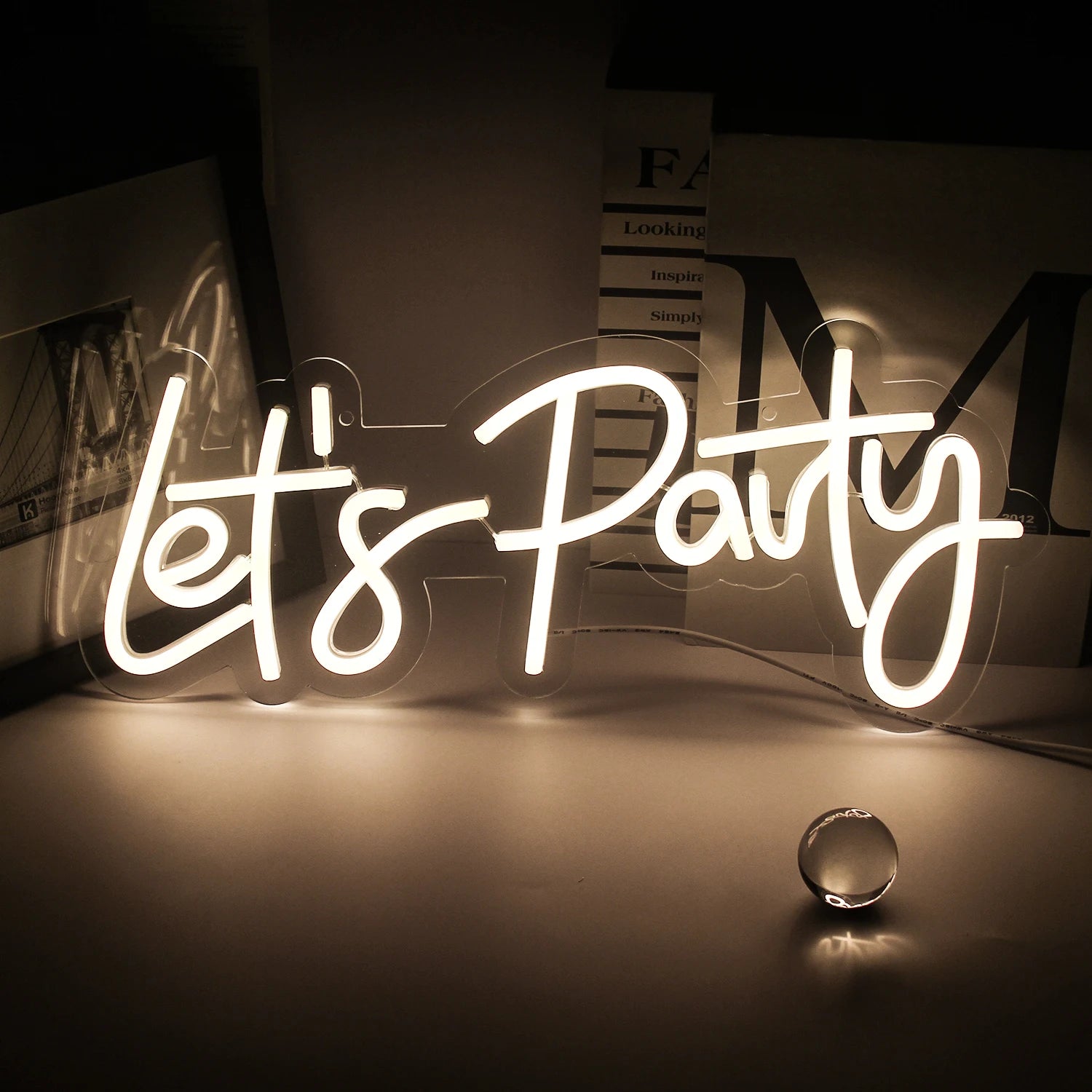 A vibrant "Let's Party" LED Neon Sign is displayed, featuring bold, cursive lettering.