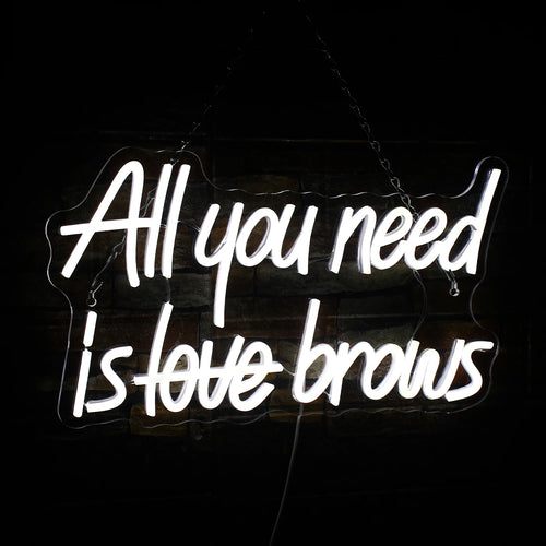 A imagem exibe um vibrante letreiro de LED neon com os dizeres "All you need is brows" (Tudo o que você precisa são sobrancelhas).