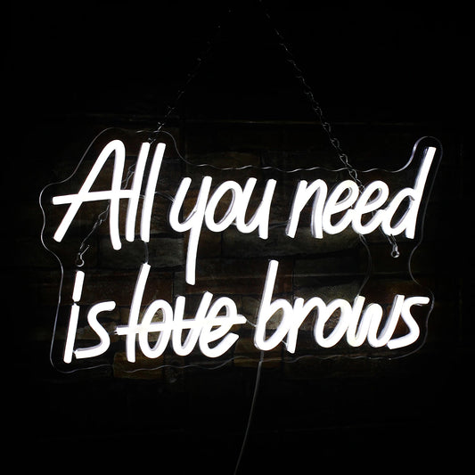 The image displays a vibrant "All you need is brows" LED neon sign.