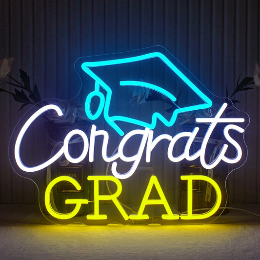 A brightly lit neon sign that reads "Congrats Grad" in a sleek, modern font.