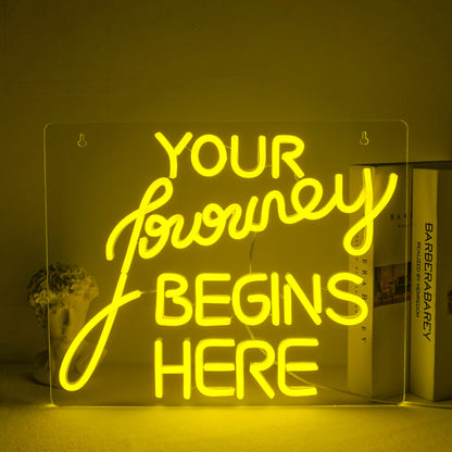 "A handcrafted LED neon sign displaying the words 'Journey Begin' in a flowing script font.
