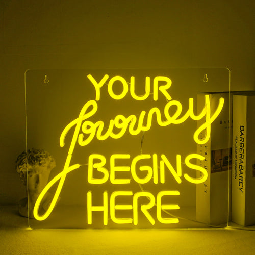 "A handcrafted LED neon sign displaying the words 'Journey Begin' in a flowing script font.