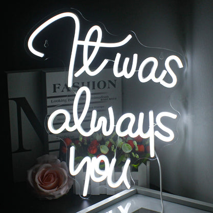 The image features a handcrafted LED neon sign displaying the words "It Was Always You" in elegant, cursive script.