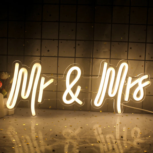 The image features a stylishly designed LED neon sign displaying the phrase "Mr & Mrs" in elegant script font.
